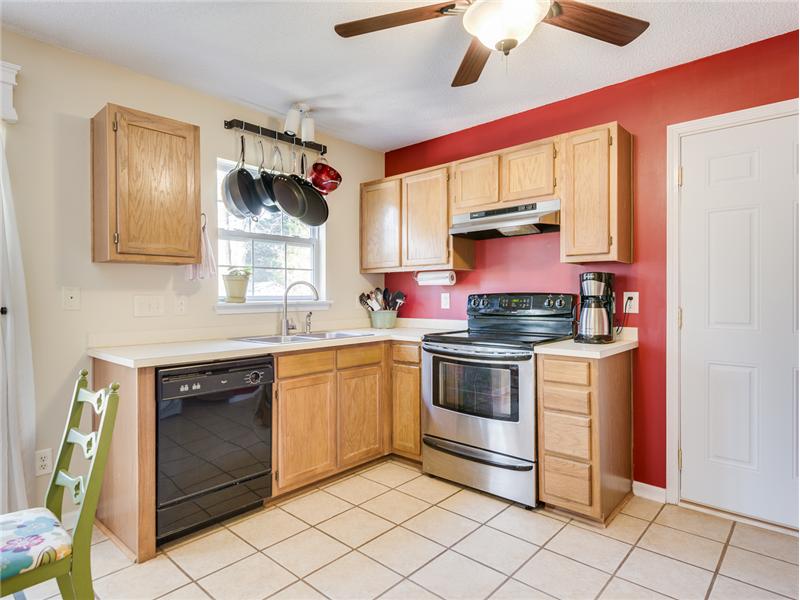 Bright and happy kitchen! Ceiling fan, pot rack and ceramic tile floors completes this cheerful space.