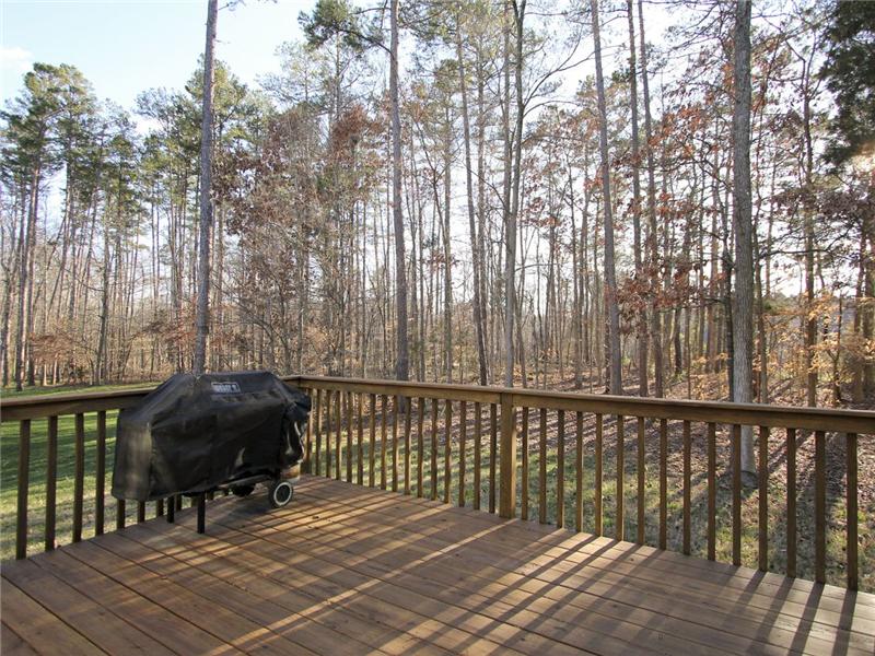 Private wooded backyard overlooks golf course