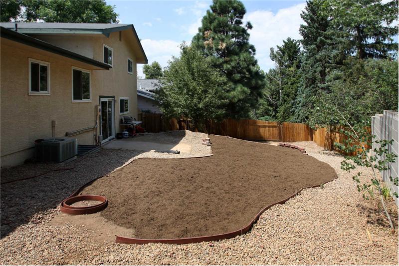 Since photo was taken, landscaping has been completed and backyard has new sod.