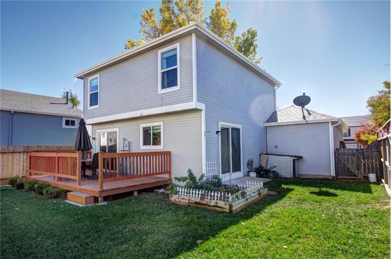 View of spacious backyard and garden.