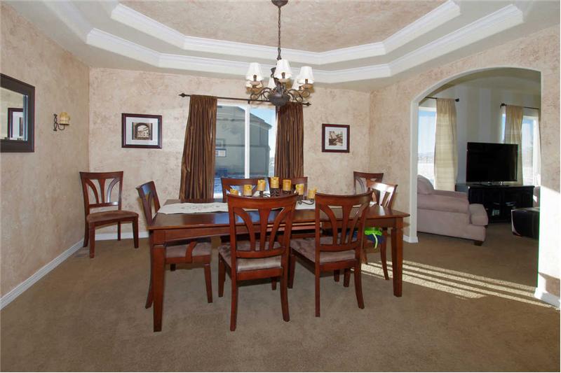 Beautiful formal dining room with a coffered ceiling and custom faux painting.