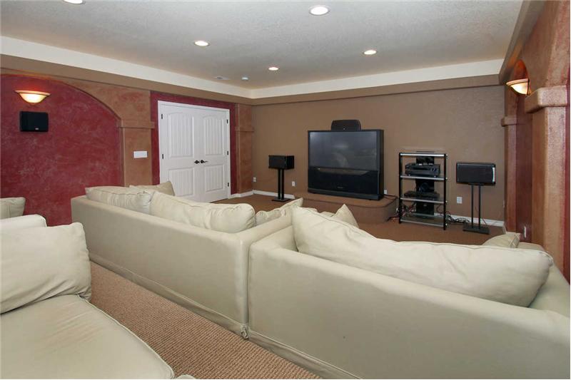 Home theater with stadium seating and dimmable lighting.