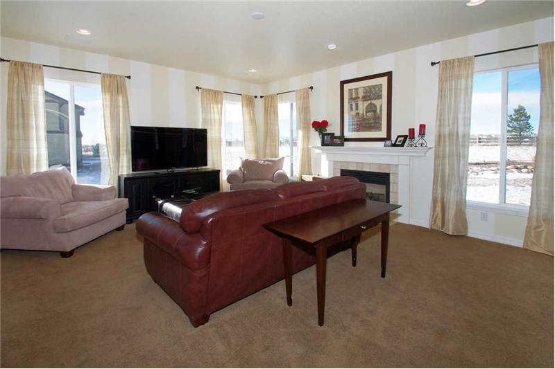 Another view of the bright great room with recessed lighting.