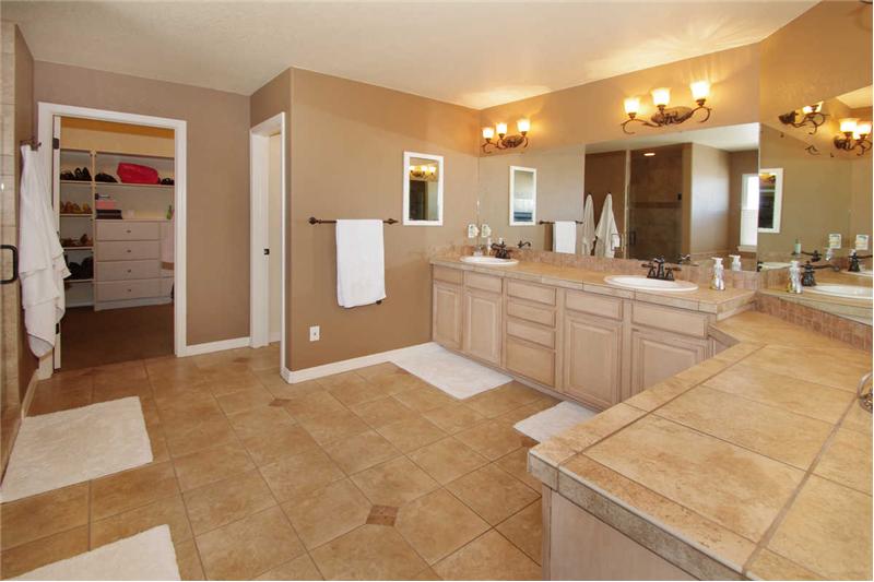 Luxurious master bath with double headed shower and jetted tub. Extra large adjoining walk-in closet offers custom built-ins!