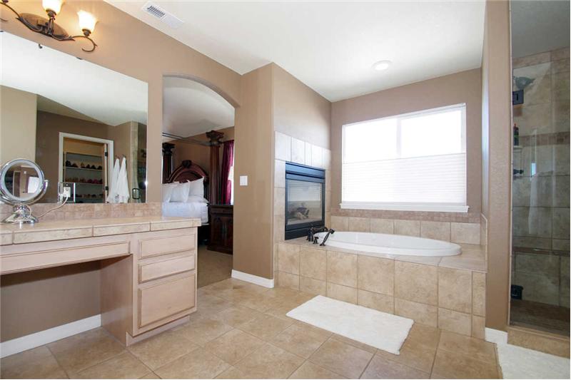 ther view of the 5-piece master bathroom and double sided fireplace