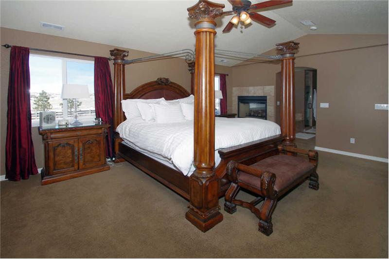 Master suite with vaulted ceilings and double sided fireplace.
