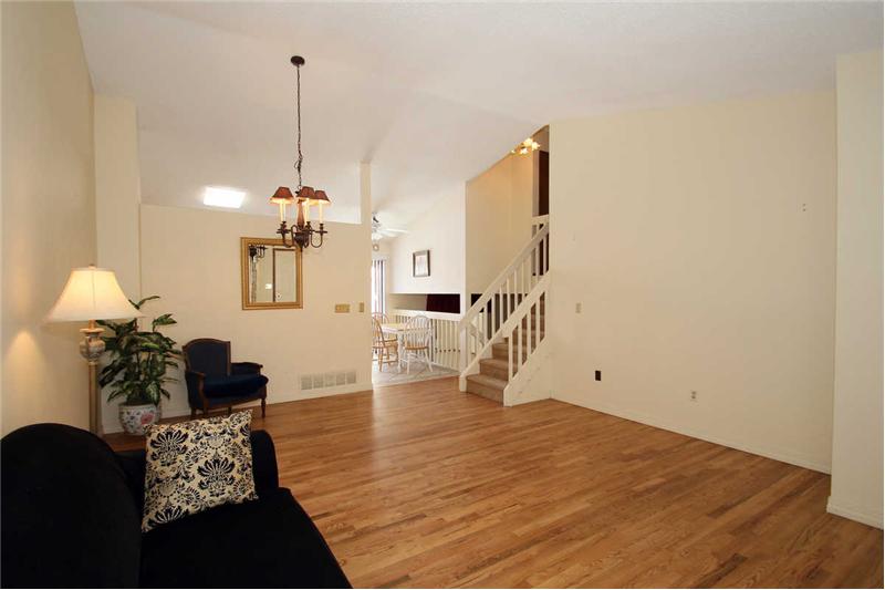 View of living room and dining area with hardwood flooring