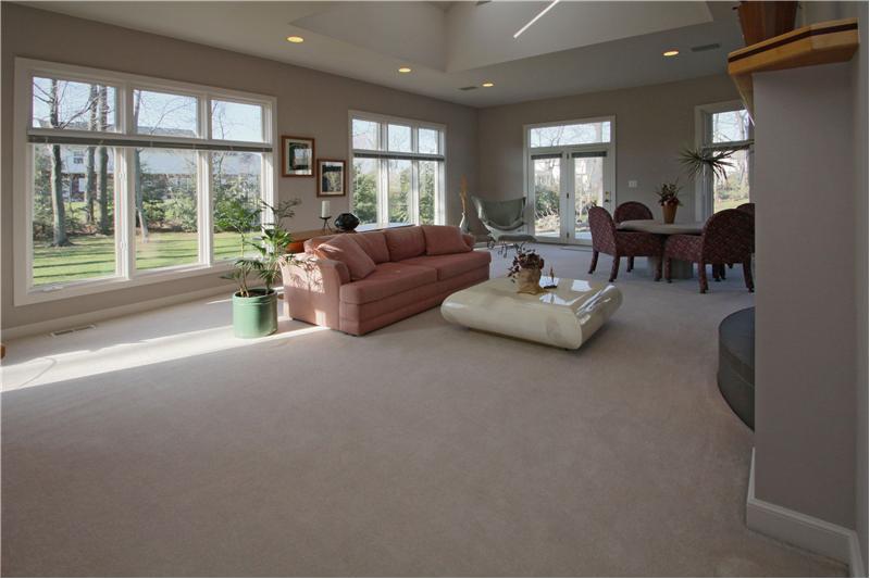 Beautiful wall of windows in your sunroom.  Dual fireplace shared with the Great Room.