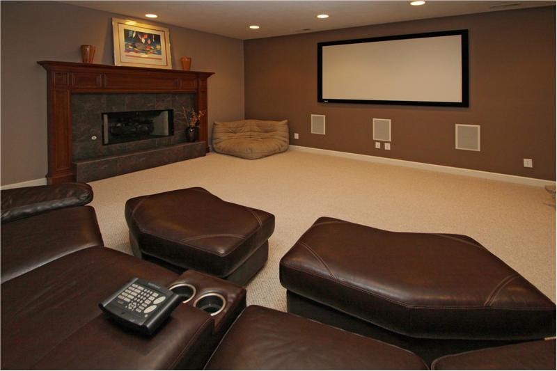 Family Room: Lower level family room with fireplace and theater equipment.