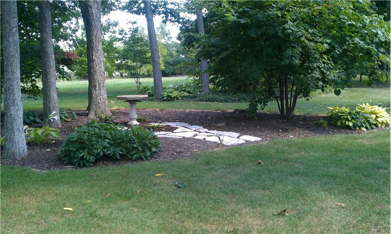 Enjoy the beauty of the 1 1/2 acre lot from your paver patio.