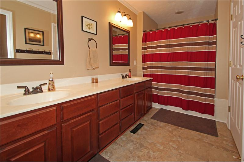 Master bathroom offers double sinks and shower/tub.