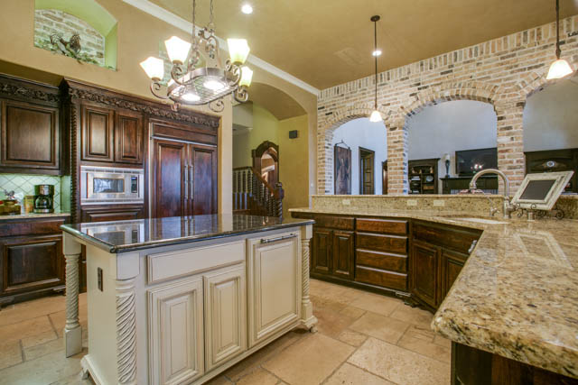 The gourmet kitchen has built ins, beautiful countertops and a large island.