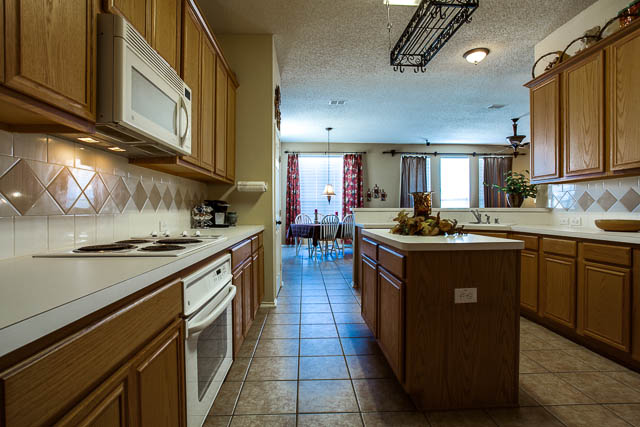 The kitchen features an island in the middle, perfect for the gourmet cook.