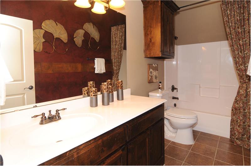 A second full bath is plenty spacious and has nice light fixtures.