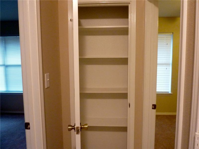 A linen closet located in the home is great for extra storage space.