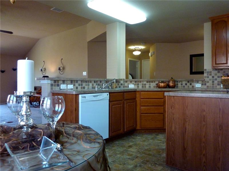 The large kitchen is complete with decorative lighting and an island.