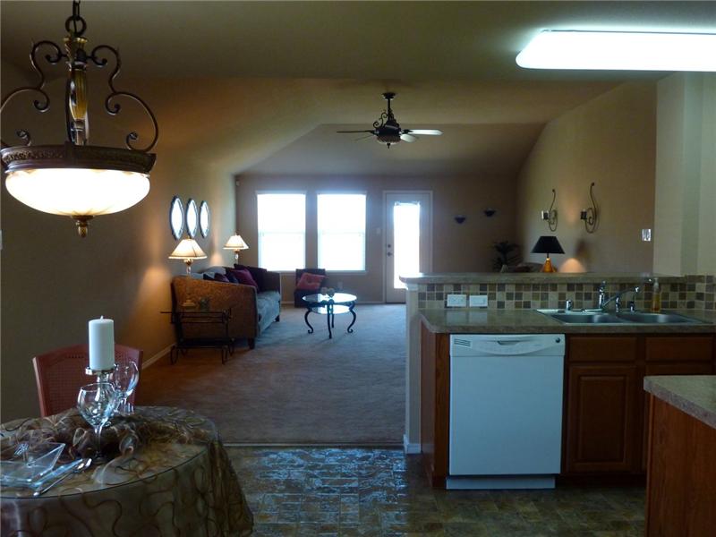 Enjoy natural light and a view of the living room from the kitchen.