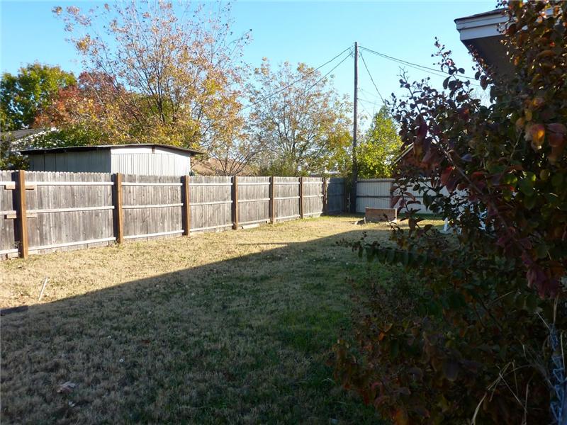 The backyard is spacious with lots of shade.