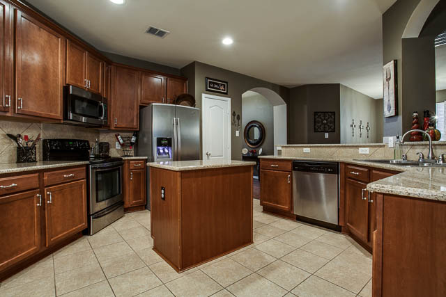 The kitchen offers granite counter tops and stainless steel appliances.