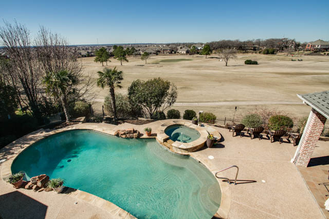 Enjoy the view of the golf course and pool in backyard from the second-story balcony.