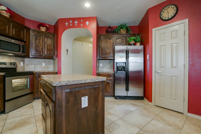 The kitchen has a large pantry, island, and breakfast bar.