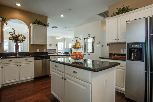 Granite countertops and an island are features of this gourmet kitchen.