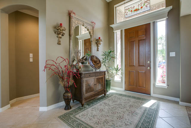 As you walk into this immaculate home, notice all the details: crown molding, rounded corners, decorative lighting, etc.