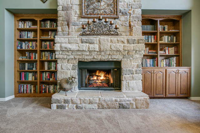 Take note of the gorgeous stone fireplace with surrounding built ins