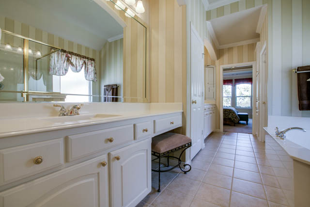 Plenty of counter space, dual sinks, and separate shower complete this master bath.