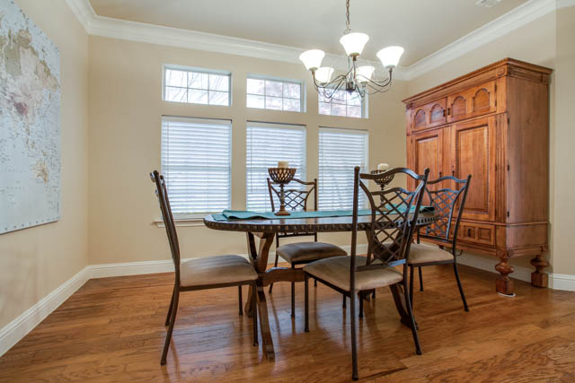 Dine in formal dining room with decorative lighting.