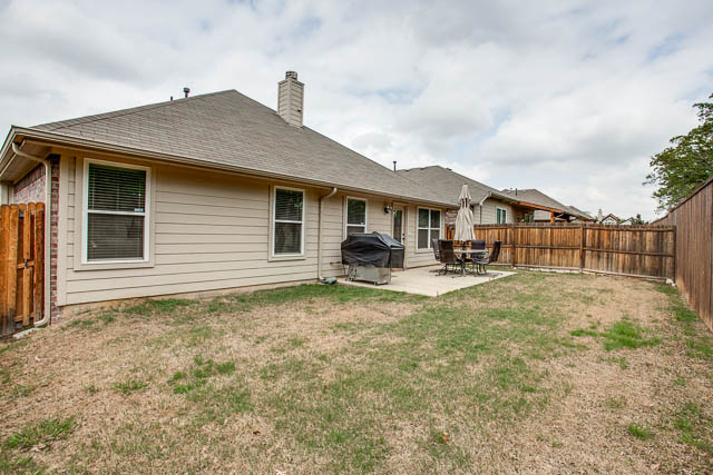 Wood fencing surrounds this spacious yard.