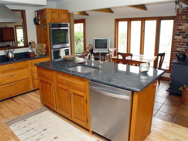 Kitchen with view of breakfast area. Newly-installed hardwood floors. 