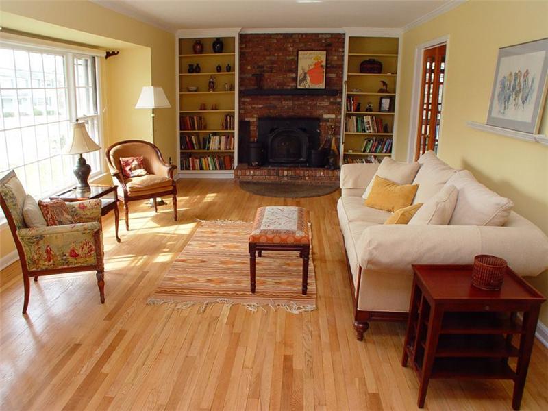 Living Room Living room. Hardwood floors and brick fireplace with wood-burning stove insert. 