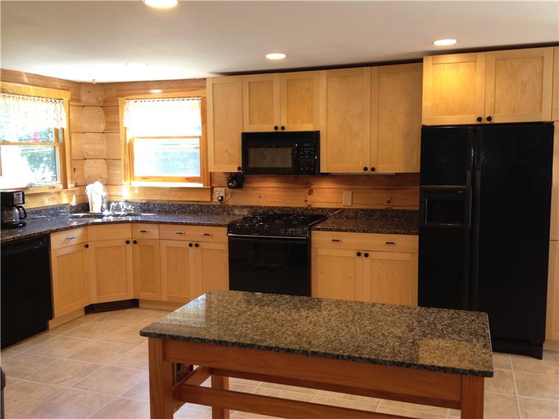 Maple cabinetry, granite counters, new appliances, tiled floor & recessed lighting