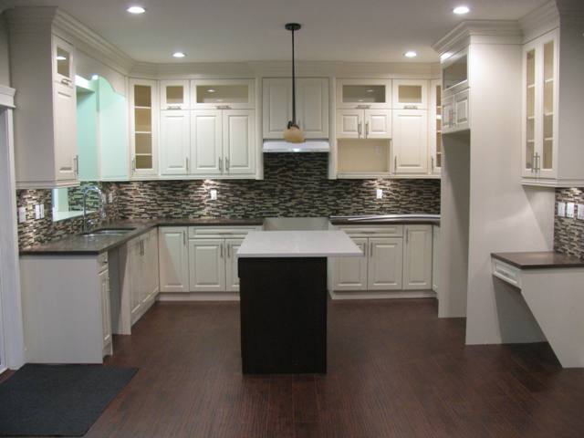 Kitchen showing cabinets, laminate floor and side desk