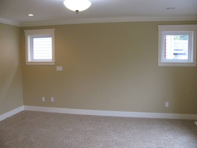 Master bedroom with pot lights and side windows, crown mouldings and baseboards