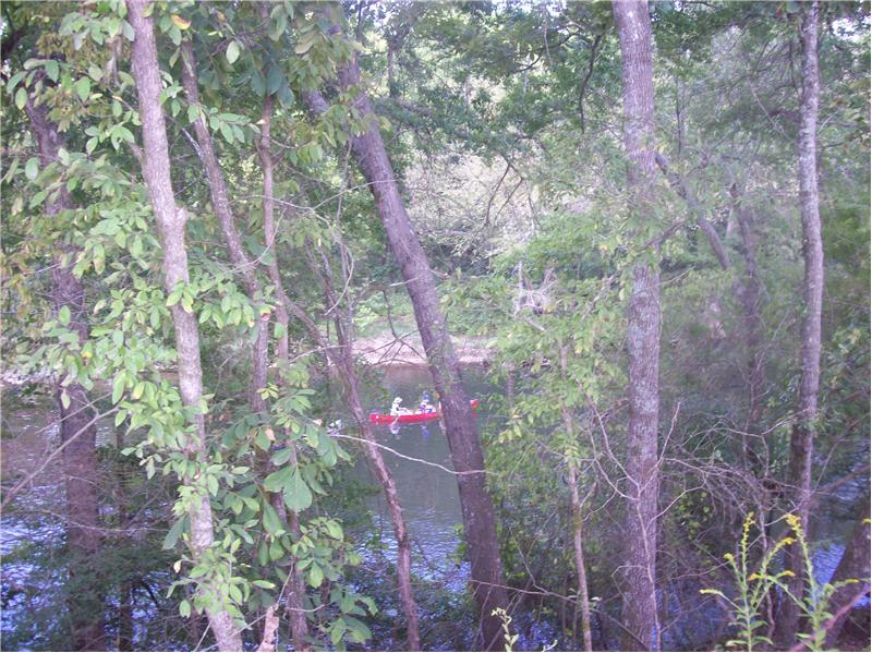 Red canoe below in river